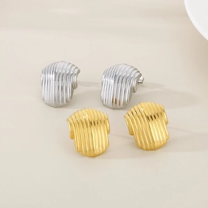 Close-up of vertical striped hollow semi-circle earrings in gold and silver finish