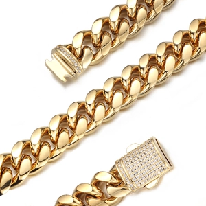 Close-up of gold Cuban link chain with a sparkling diamond-encrusted clasp closure