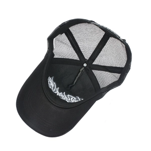 Close-up of interior embroidery and breathable mesh detail on a black trucker cap