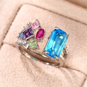 Detailed macro shot of an open silver ring with colorful rectangular zircon gemstones