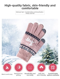 Detailed view of pink knitted winter gloves with reindeer pattern and touch screen fingertips