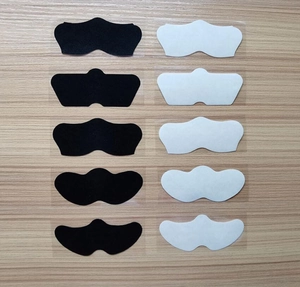 Flat lay of 10 bamboo charcoal nose strips in black and white colors on wood background