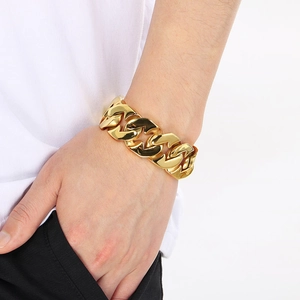 Men's 24mm heavy gold stainless steel Cuban link bracelet in hip hop style on wrist