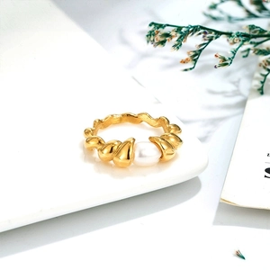 Macro shot of 14k gold-plated twisted croissant ring with a natural freshwater pearl