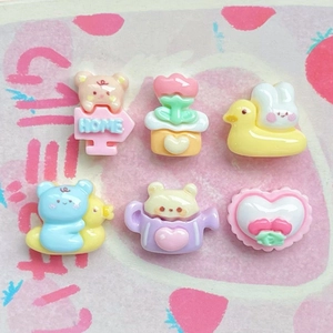 Flat lay of colorful DIY resin accessories featuring mini bear, duck and teapot shapes