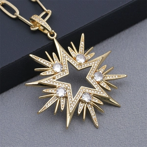Macro shot of gold-plated star pendant necklace with crystal pave and jewelry details