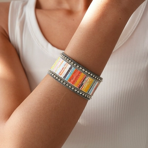 Detailed view of bohemian wide cuff bracelet with colorful stripes and crystal trim
