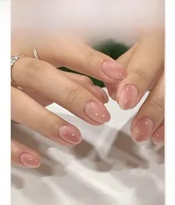 Detailed view of glossy nude pink short oval press on nails with jelly texture JP4138