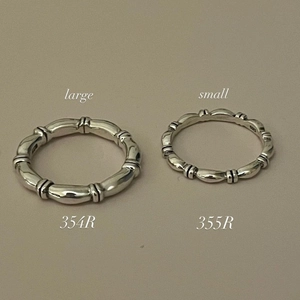 Macro detail of 925 sterling silver bamboo rings in large and small sizes