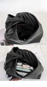 Macro view of large capacity black lychee grain leather bag with magnetic closure