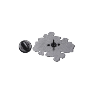 Detailed back view of a heart puzzle metal brooch pin with its black rubber clutch backing