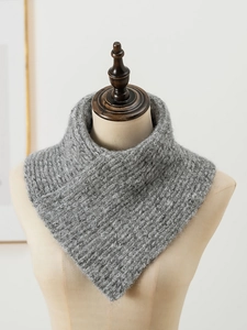 Close-up of gray chunky knit infinity scarf texture on a neutral mannequin bust
