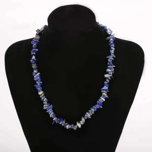 Lapis lazuli natural crystal gemstone chips necklace on black jewelry display stand