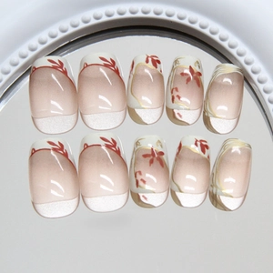 Handmade press-on nails with French golden edges and red maple leaf floral design
