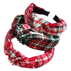 Detailed view of three plaid Christmas headbands in red and green festive tartan patterns