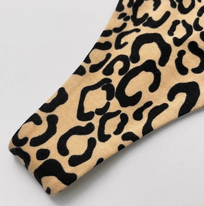 Close-up of leopard print knit fabric texture with high-density brown and black patterns