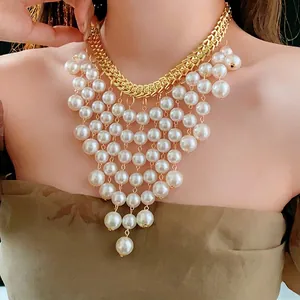 Luxury layered pearl tassel necklace with gold-tone metal chains on model