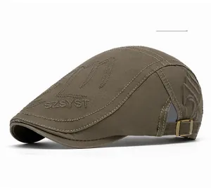 Detailed side view of military green newsboy cap with metal buckle and side embroidery