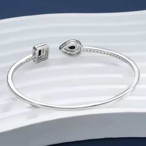 Macro detail of adjustable silver bangle featuring emerald-cut black stones and Pavé zircons