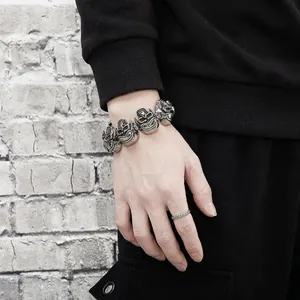 Mens retro punk stainless steel rock skull bracelet and textured ring set on wrist