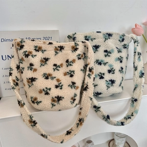 Detail of plush bucket bags with floral patterns and soft fleece texture shown in a set