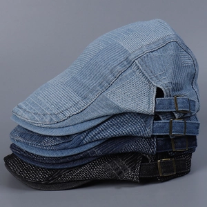 Detailed stack of vintage denim flat caps with irregular check patterns in four color shades