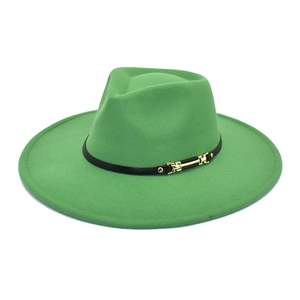 Detail of green felt fedora featuring a gold chain buckle on a black leather band