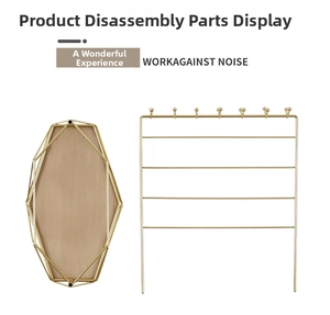 Disassembled parts of a gold iron jewelry display stand with a hexagonal wooden base
