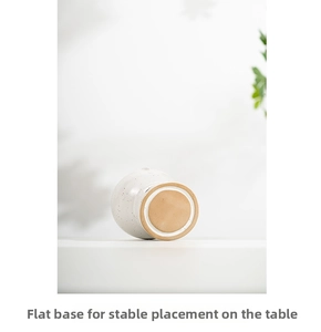 Flat base of the cream ceramic aromatherapy burner for stable tabletop placement
