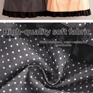 Detailed macro view of polka dot canvas apron fabric with ruffles and breathable texture