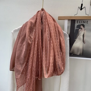 Detail showing the fine lace trim on this linen-cotton blend scarf in dark pink