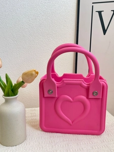 Neon pink EVA beach handbag featuring embossed heart design and sturdy double handles