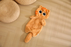 Flat lay of an orange cat plush onesie with striped hood and tail on wood floor