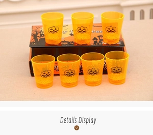 Close-up of yellow Halloween pumpkin cups with matching festive gift box packaging