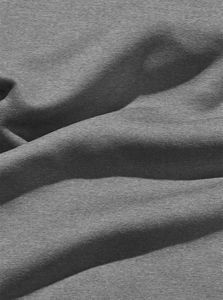 Close-up of grey fleece fabric texture with soft knit details on a pullover sweatshirt