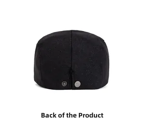 Detail view of the black fabric flat cap back with dual silver metal snap adjusters