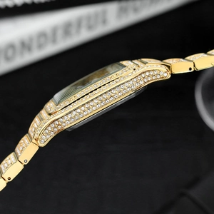 Detailed side view of luxury gold square watch with dense iced-out diamond settings