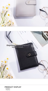 Detailed view of litchi grain leather passport holders with gold airplane clasp