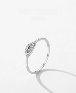 Detailed macro view of S925 sterling silver Evil Eye ring with blue gemstone and pavé stones