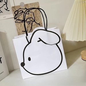 Minimalist white paper gift bag with cute rabbit illustration and black handles