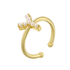 Detailed macro view of a gold-finish cross ear clip set with elegant white pearls