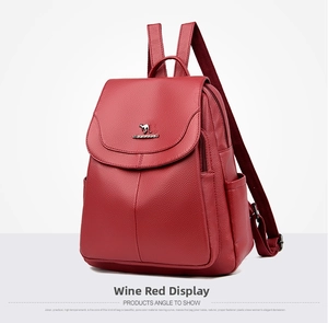 Detail view of burgundy pebble leather backpack with metallic buckle and flap closure