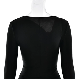 Rear view detail of a slim-fit black long sleeve dress featuring center vertical seam