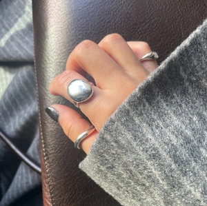 Polished 925 sterling silver minimalist rings shown worn on hand with knit background
