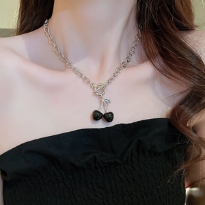 Close-up of black cherry pendant necklace with silver OT buckle on model neck