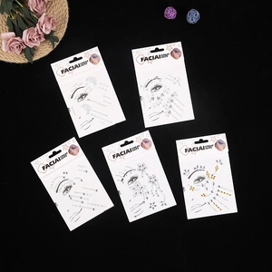 Flat lay of multiple silver and gold face gem sticker packs with floral and star designs