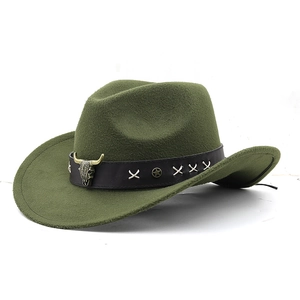 Detail of olive green wool cowboy hat featuring a leather band and metal bull skull emblem