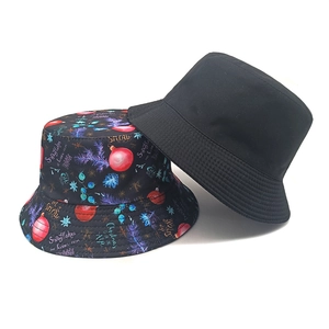 Christmas reversible bucket hat with festive snowflake print and solid black cotton fabric