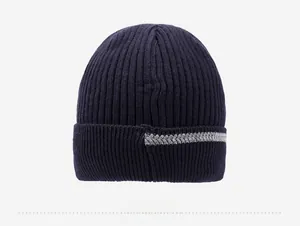 Rear view of navy blue ribbed knit beanie featuring gray herringbone detail on the cuff