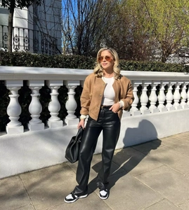 Outdoor street style view of brown wool cropped jacket and black faux leather trousers